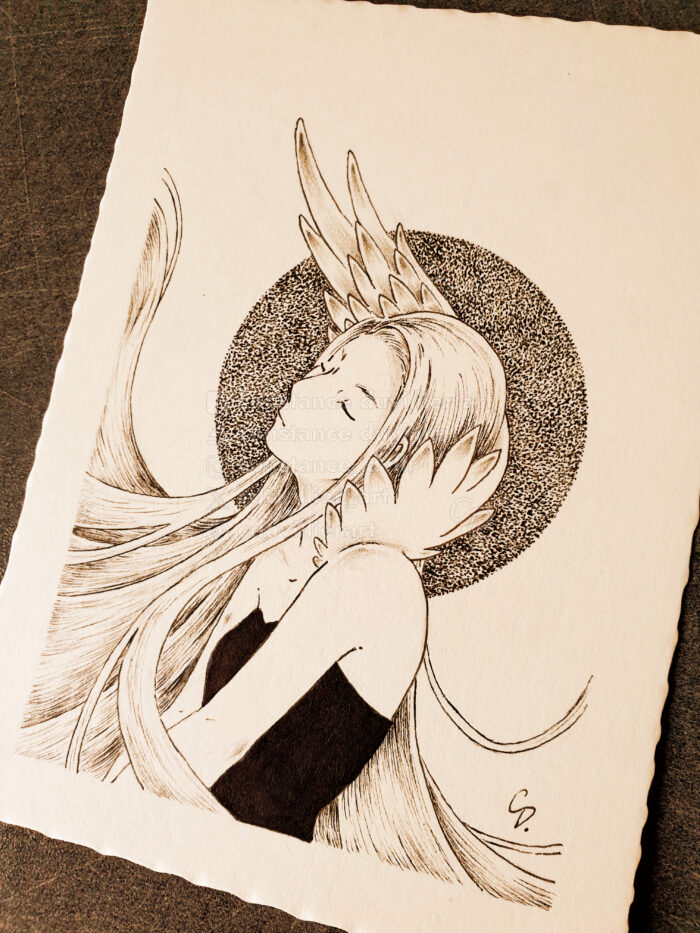 Photo of a black and white drawing. There's a sepia filter on the photo, and the table on which the drawing is placed is black. The drawing represents a young woman from her head to her torso. She has white, long hair and closed eyes. She doesn't smile, she wears a black sleeveless top. Her body is turned to the left, her arms are stretched forward. She has a birthmark under her right shoulder. A white wing emerges from her left shoulder and passes behind her head. Her straight hair floats more to the left than to the right. The background is white. Behind the woman's head, a black circle made with dots, it's pointillism.